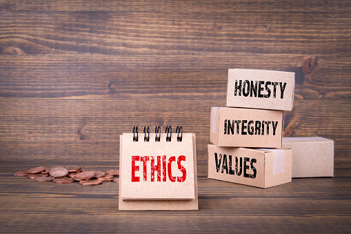 Ethics oncept. Honesty, integrity and values words. Paper boxes on wooden background