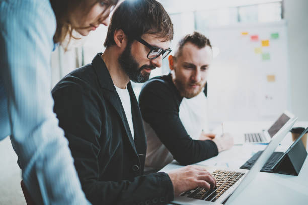 istock Concept of brainstorming process at office.Young team working together at modern office loft.Blurred background.Horizontal. 1128201892