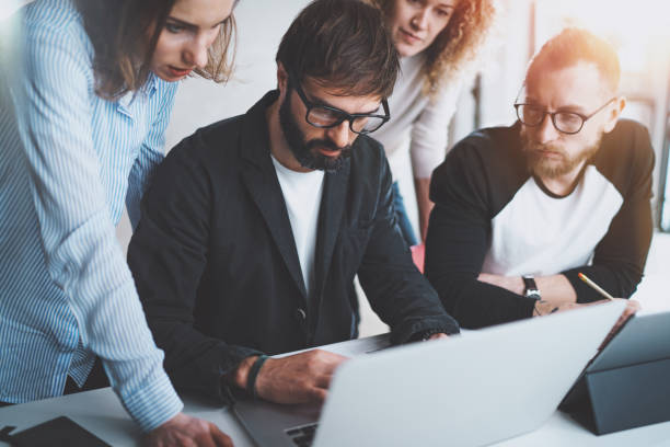istock Working process photo.Group of young coworkers working together at modern office loft.Blurred background.Horizontal. 1128201929