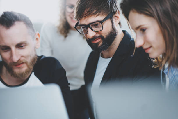 istock Group of young entrepreneurs are looking for a business solution during working time at sunny office.Business people meeting concept.Blurred background.Horizontal.Cropped. 1128202510