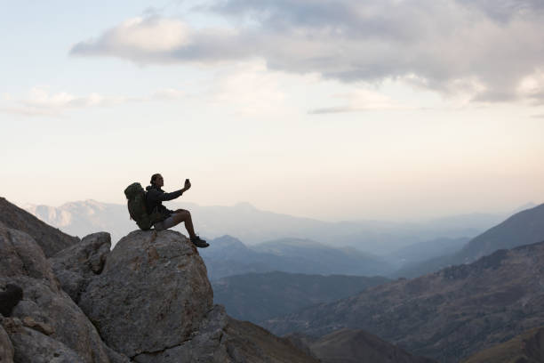 istock Hiker Use Smartphone At Mountain Peak 1128203290