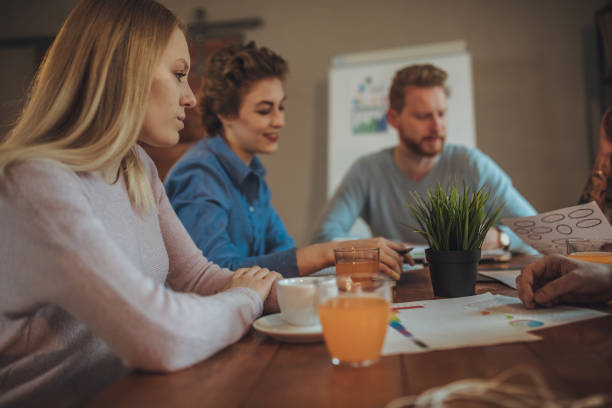 istock Young people brainstorming together in modern office 1128203338