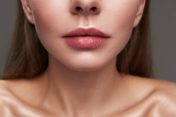 istock Attractive young woman with beautiful full lips 1128203401