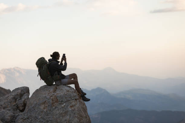 istock Hiker Use Smartphone At Mountain Peak 1128205062