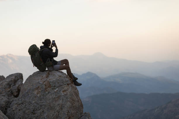 istock Hiker Use Smartphone At Mountain Peak 1128205112