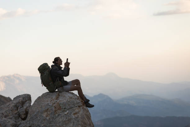 istock Hiker Use Smartphone At Mountain Peak 1128205125