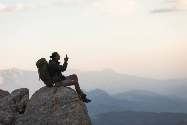istock Hiker Use Smartphone At Mountain Peak 1128205133