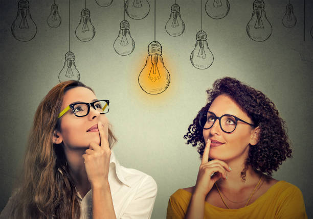 istock happy beautiful women thinking looking up 1128205373