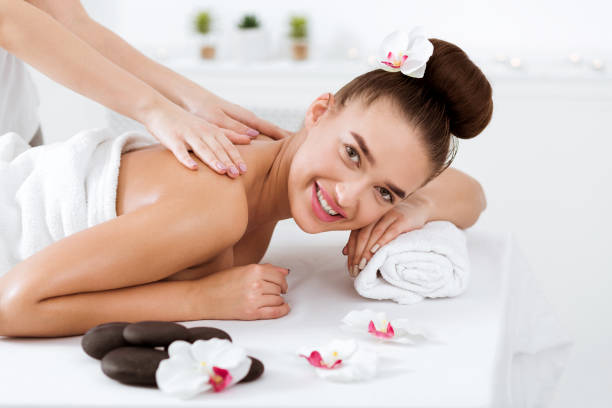 istock Woman enjoying back massage, smiling at camera 1128205589