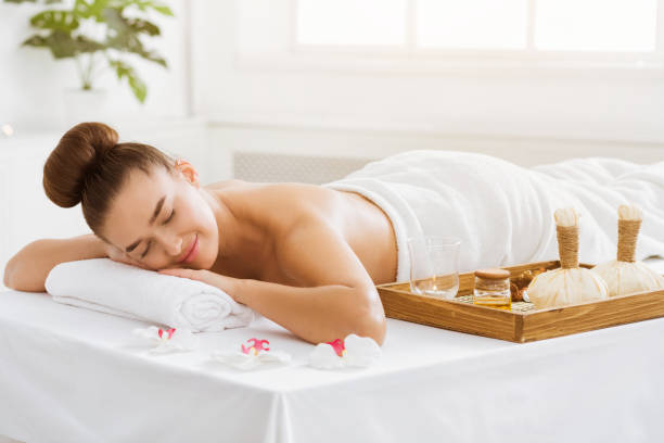 istock Young woman ready for herbal massage, lying on table 1128205597