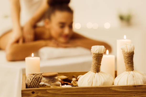 istock Aroma spa composition with candles and relaxing woman 1128205601