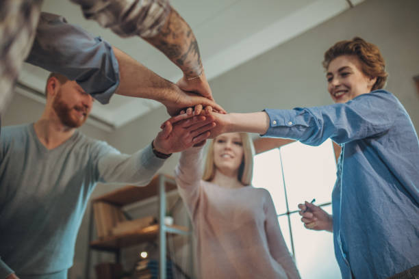 istock Young business people holding hands 1128206769