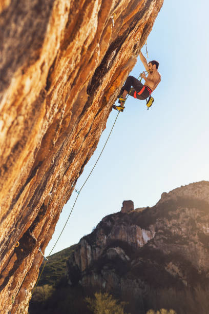 istock Young man sport climbing in overhanging position 1128206930