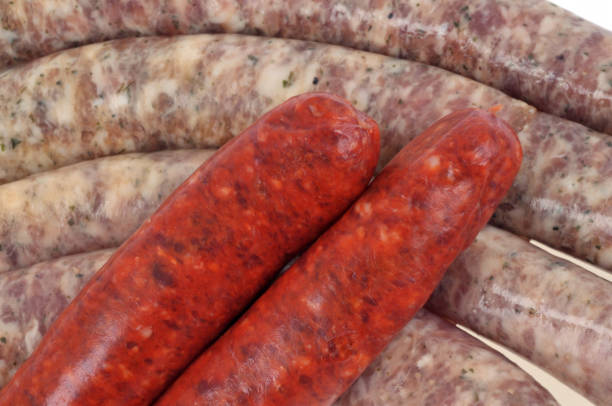 Merguez and raw chipolatas Merguez and raw chipolatas in close-up grillade stock pictures, royalty-free photos & images