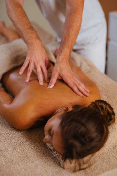 istock Young woman getting back massage from a massage therapist 1128213142