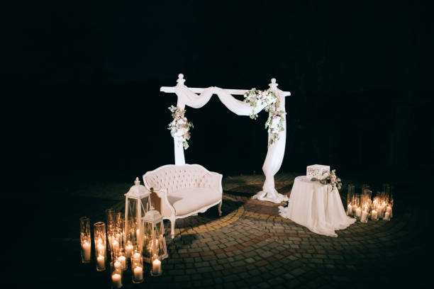 istock Arch with fresh flowers for a wedding ceremony  at night 1128216019