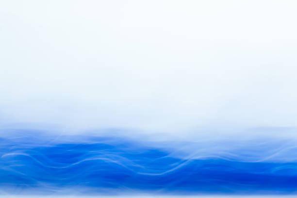 istock Abstract blurred light effect of blue wave on a white background. Long exposure photo of moving camera 1128216022