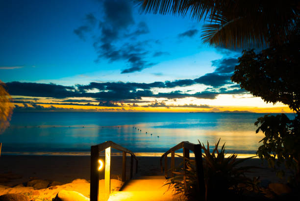 Beautiful peaceful sunset with palm coconut tree on a sandy beach for family holiday and romantic lover couple honeymoon retreat for mind body soul spirit love meditation