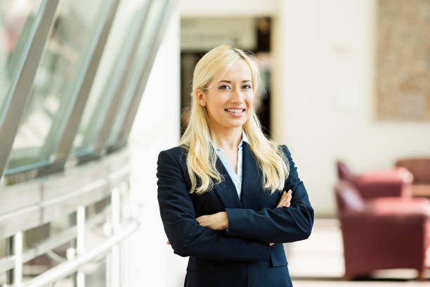 istock business woman in black suit, smiling 1128218337