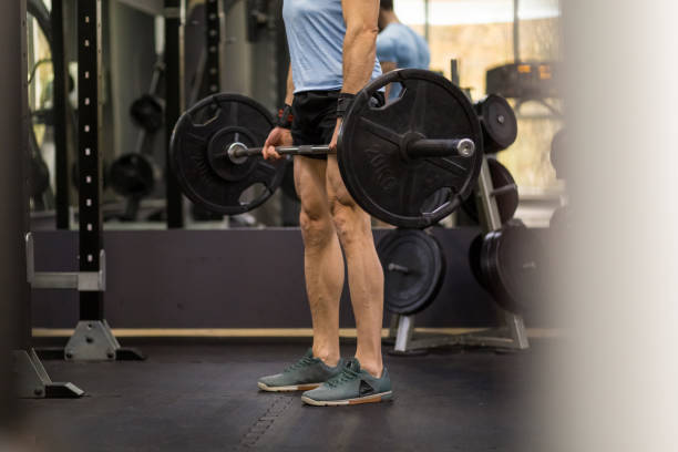 istock Image of a muscular man pulling a heavy barbell at the gym. 1128220776