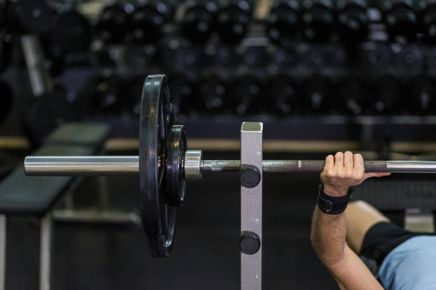 istock Close up image of man doing bench press at the gym. 1128221109