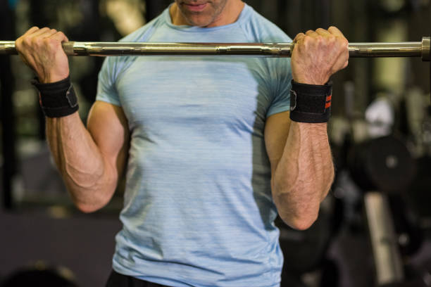 istock Close up image of man using barbell at the gym. 1128221528