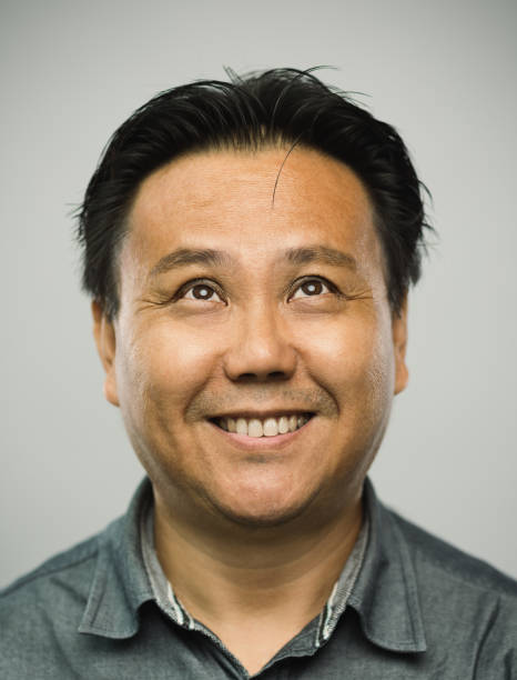 istock Real chinese mature man with happy expression looking up 1128221713