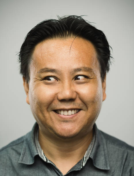istock Real chinese mature man with happy expression looking to the side 1128221768