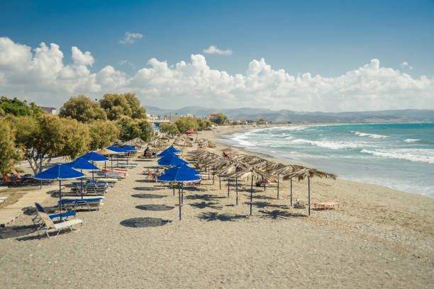 istock Umbrellas and deck chairs on the beach by the sea against a cloudy sky 1128227154