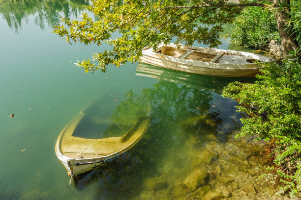 istock Two boats in the park under the trees 1128227194