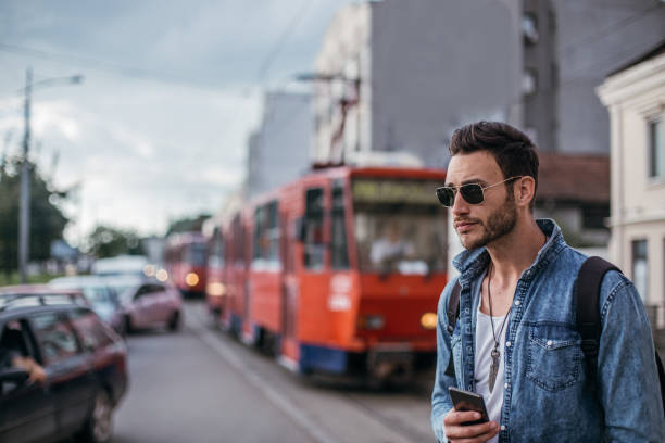 istock Handsome man using mobile phone on the street 1128228218