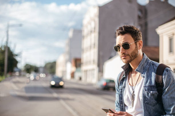 istock Modern man using mobile phone on the street 1128228698