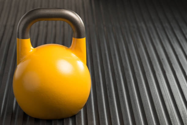 istock Yellow 16kg weight lifting kettlebell inside a gym 1128228828