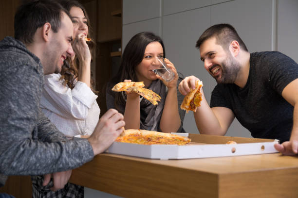 istock Friends heaving great time and eating pizza 1128230178