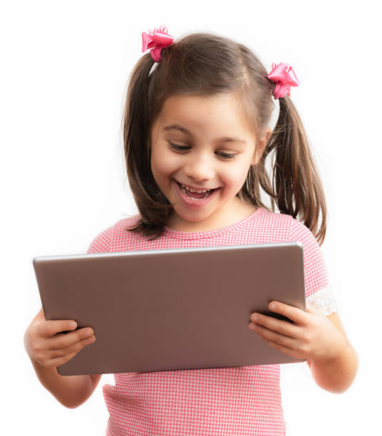 Happy Little Child Girl Using Digital Tablet, Isolated on White Background Happy Little Child Girl Using Digital Tablet, Isolated on White Background graphics tablet stock pictures, royalty-free photos & images