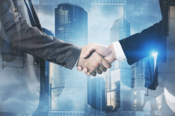 istock Men shake hands in blue Moscow city 1128232956