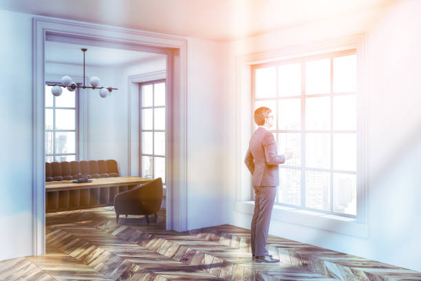 istock Businessman standing in white living room 1128233767