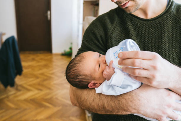 istock Father feeding newborn baby boy 1128233962