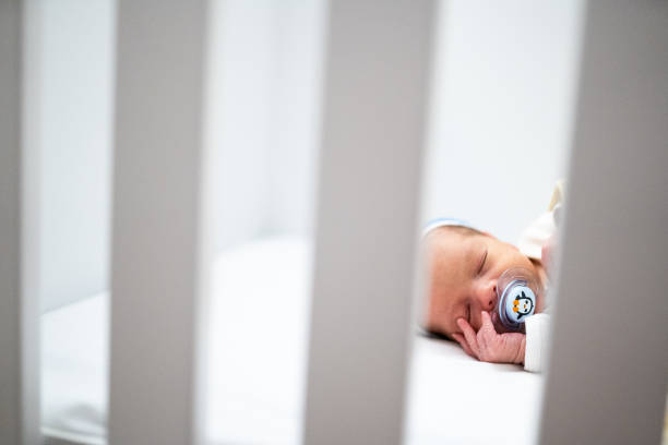 istock Newborn baby sleeping in crib 1128234039