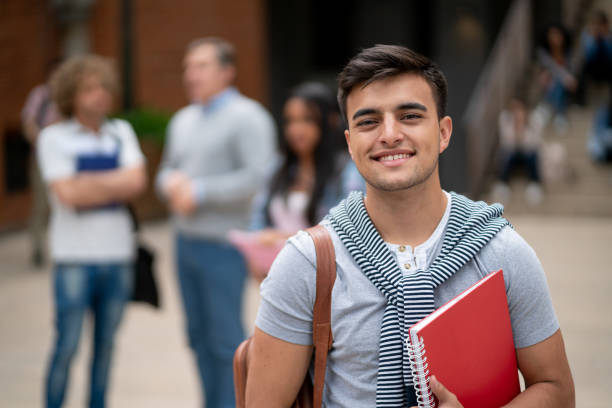 istock Cheerful young male student at university campus facing camera smiling 1128235764