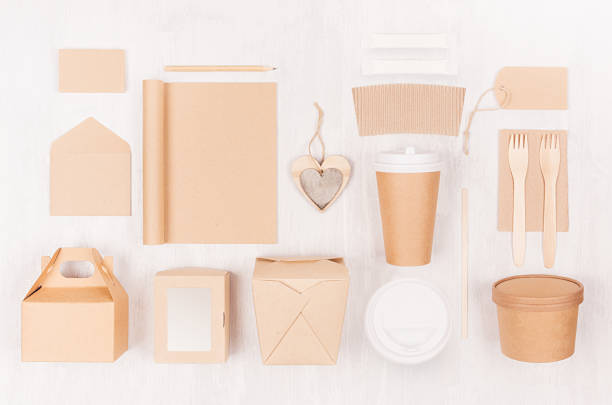 istock Mockup food takeaway packaging for cafe and restaurant - cardboard box for coffee, burger, noodles, sandwich, sushi on light white wood table. 1128236115