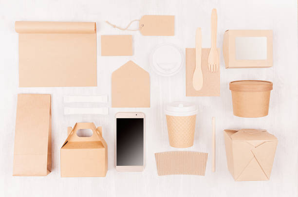 istock Food branding identity mockup in light modern style - blank screen phone,  cup, packet, box, label, card, container of brown paper  on white wood board. 1128237137