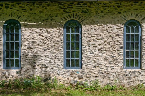 istock Old building made from slag stone with blue vaulted windows 1128238899