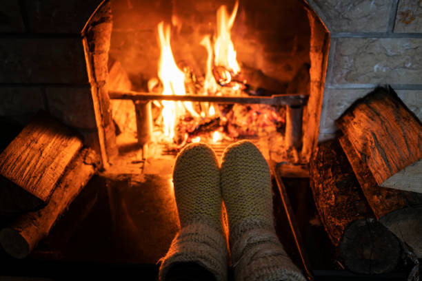 istock Foot in wool socks warming by the fireplace 1128238936
