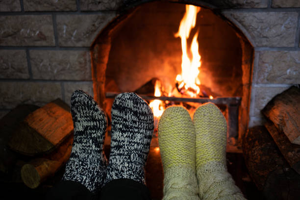 istock Foot in wool socks warming by the fireplace 1128239072