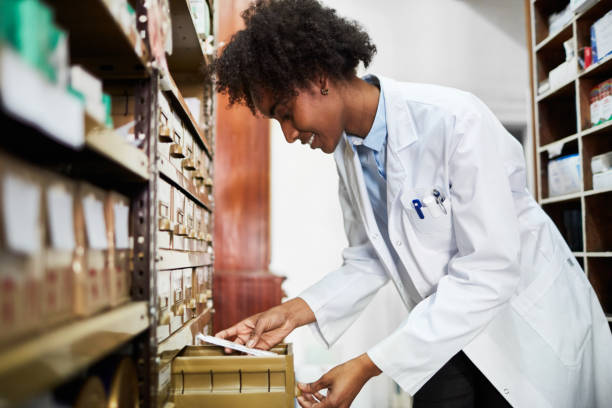 istock Female pharmacist looking for medicines in the rack 1128239175