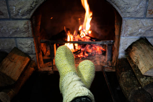 istock Foot in wool socks warming by the fireplace 1128239752