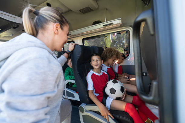 istock Happy mother transporting boys to a soccer camp in a van 1128240823