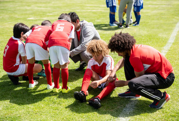 istock Soccer coaches helping a group of kids get ready before the game 1128240896