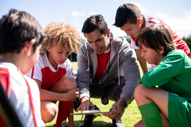 istock Man coaching a group of boys in soccer practice 1128240902